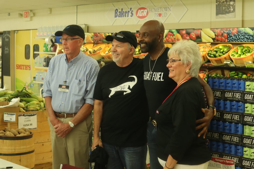 Former NFL superstar Jerry Rice poses with Baker's IGA supermarket staff and management in Newcomerstown, Ohio on Friday, September 3.