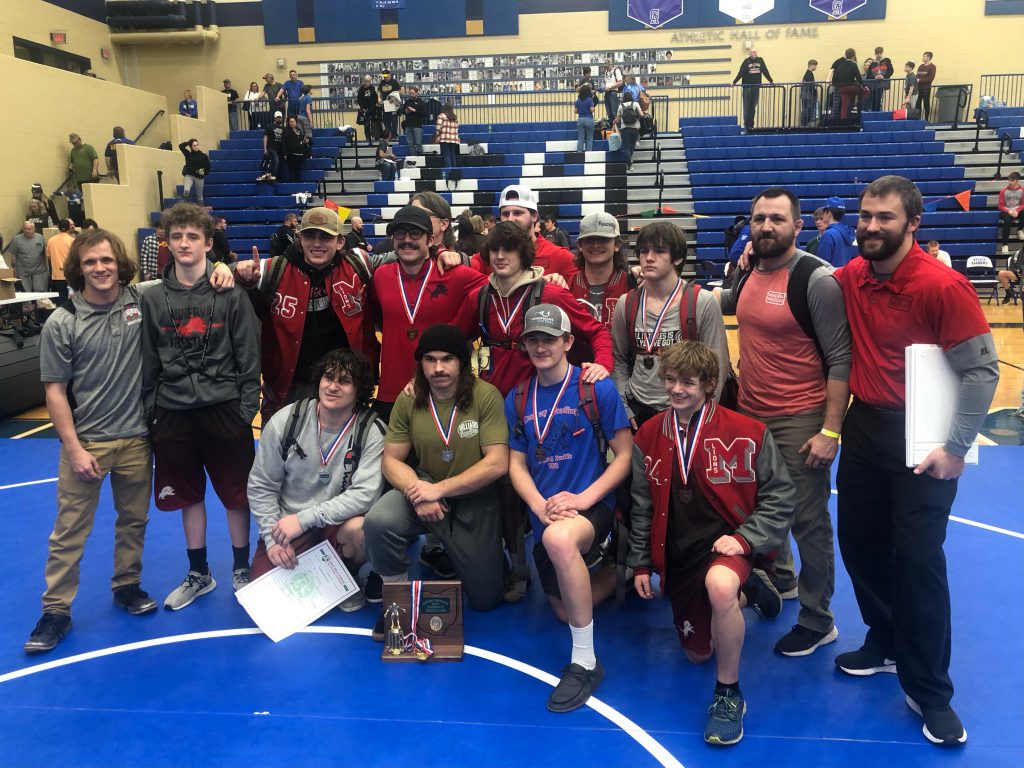 Minerva High School's boys wrestling team celebrates after winning the OHSAA Division II District tournament on Saturday, Mar. 5 at Gallia Academy. (Photo credit: Joe Chaddock)