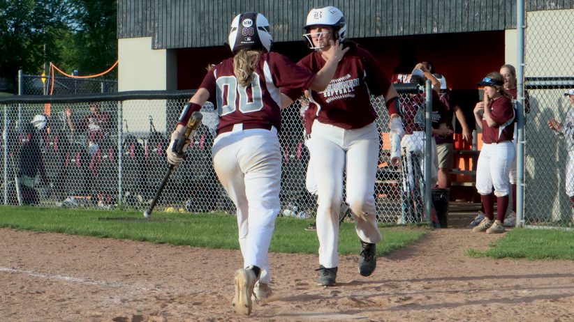 Boardman's Josie Porter (00) is greeted after scoring a run in the 8th inning of Boardman's 5-3 Division I District final win over New Philadelphia on Tuesday.