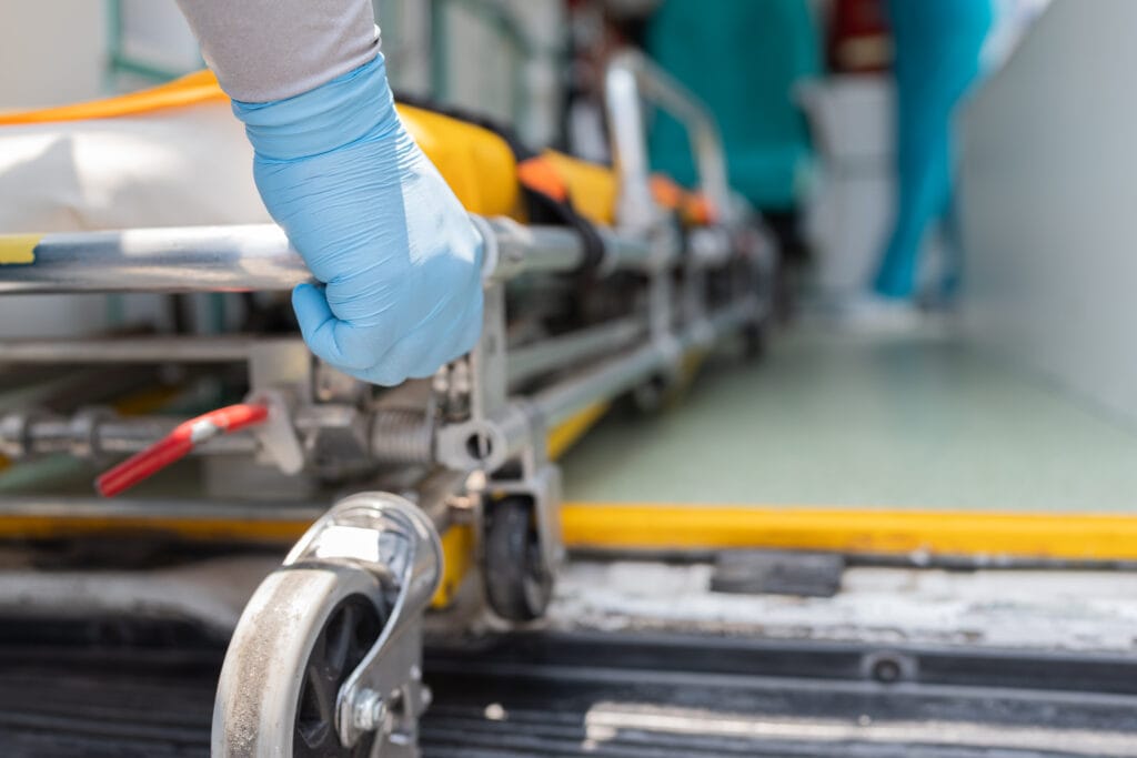 detail of a hand of an ambulance crew working with a stretcher