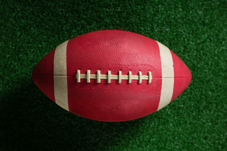 close up of american football on artificial turf